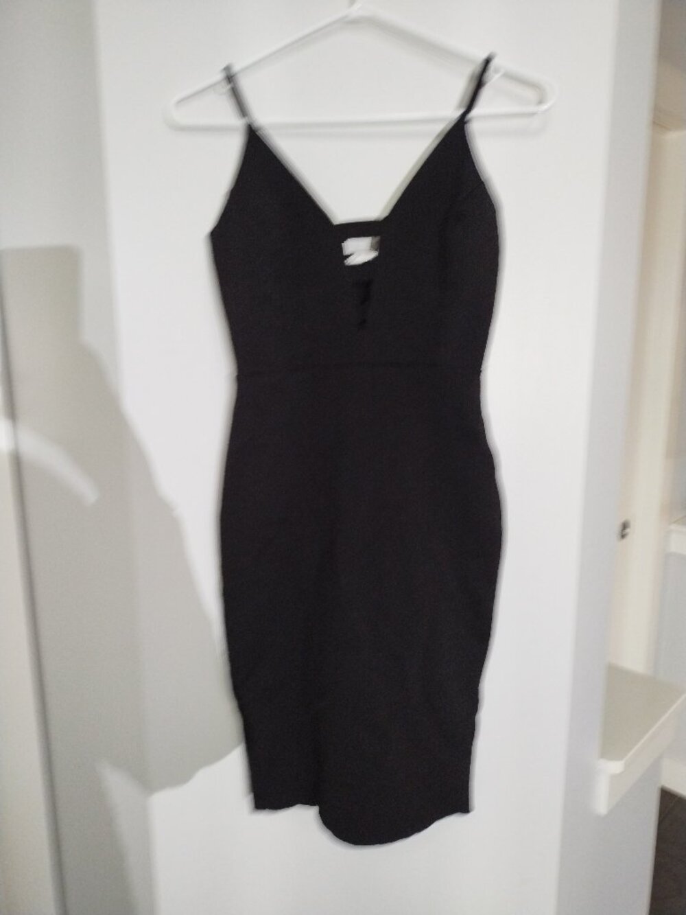 Black mini dress with stretch and cutouts in the neckline